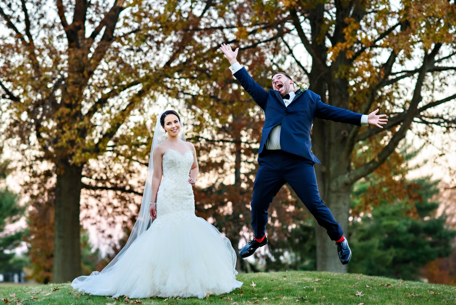 A groom jumps for joy after his bride says yes.